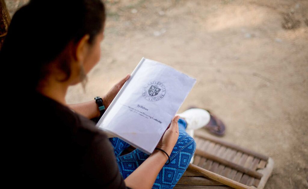 Photo of Pheap holding her syllabus