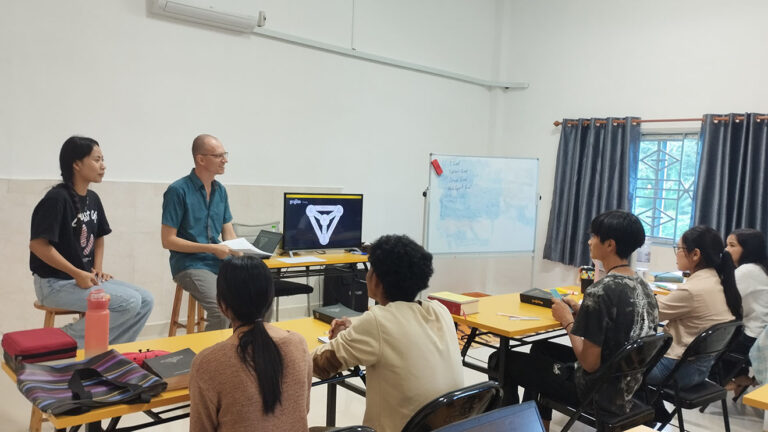 photo of Pat in front of a DTS class teaching Cambodian youth on the nature and character of God.