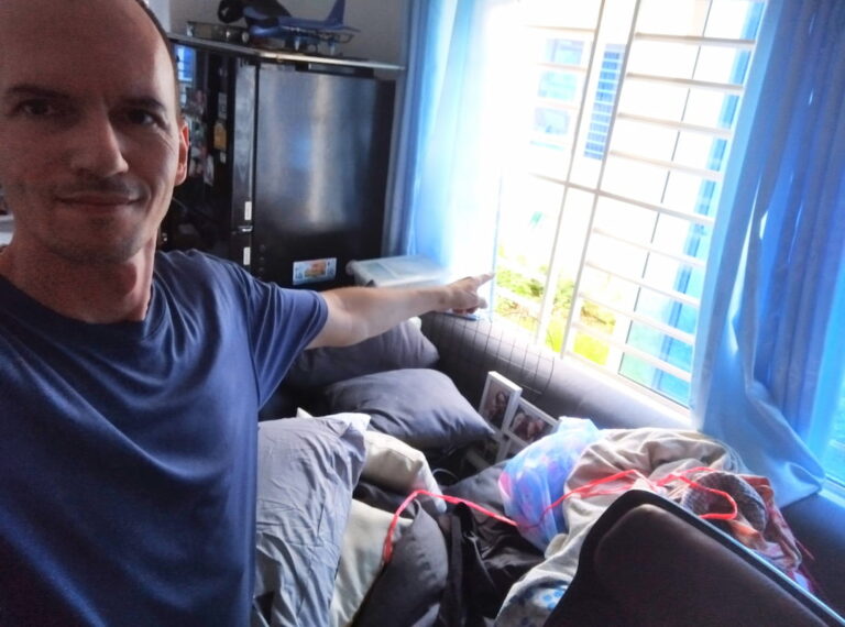 Photo of Pat pointing to a window letting in light